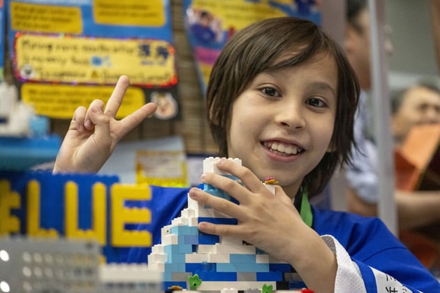 child building with legos