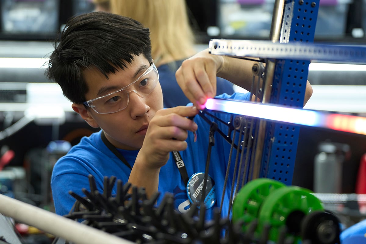 FIRST Robotics Competition student working on their robot at FIRST Championship