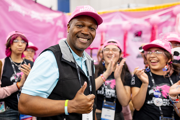 FIRST CEO Chris Moore visits robotics teams in the pits.